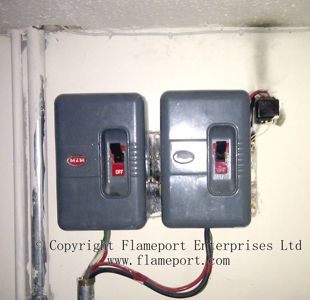 Overheated doorbell transformer with soot marks up the wall