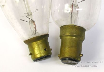 Two styles of small bayonet cap on some old glass candle lamps