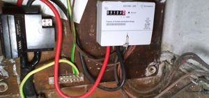 Modern electricity meter connected to 1950s rubber wiring