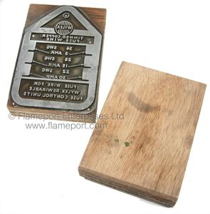 Metal printing plates for Wylex fusewire cards, mounted on a plywood base