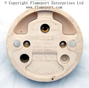 Round plastic light switch made by ROLLS Switches Ltd
