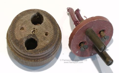Two pin plug taken apart, showing the pins, wooden body and wiring