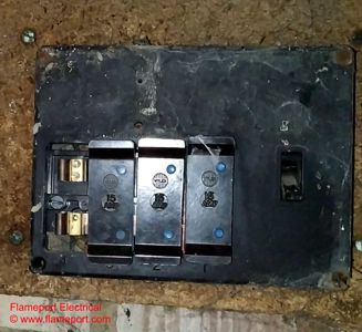 Old rewireable fusebox with missing shield and exposed live parts